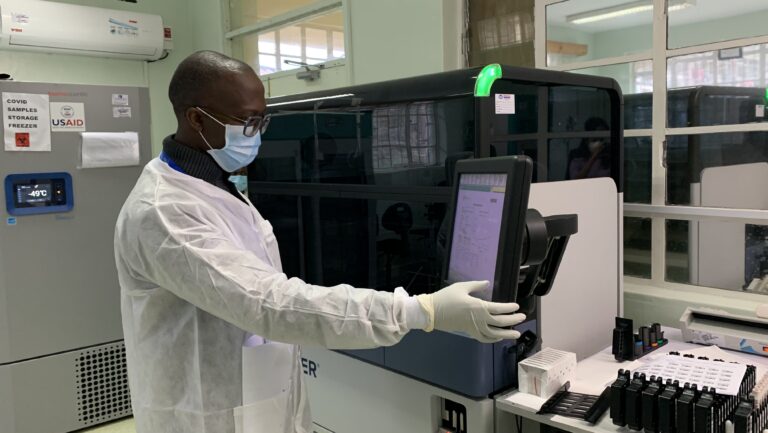A lab technician using the Hologic Panther machine