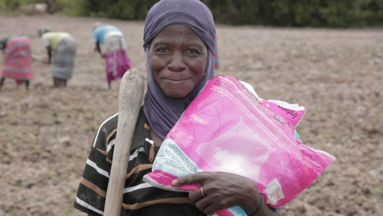 A woman holding an Interceptor® G2 mosquito net at a distribution site, Yanfolila, Mali.