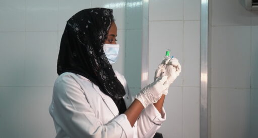 A health care worker prepares the COVID-19 vaccine before she vaccinates people