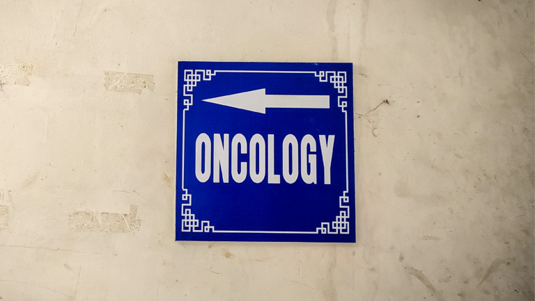 A blue sign with the word 'Oncology'
